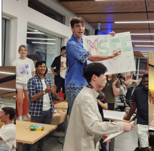 ESSS students holding up a handmade sign at a past event