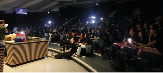 A packed auditorium of students during a Midnight Madness event