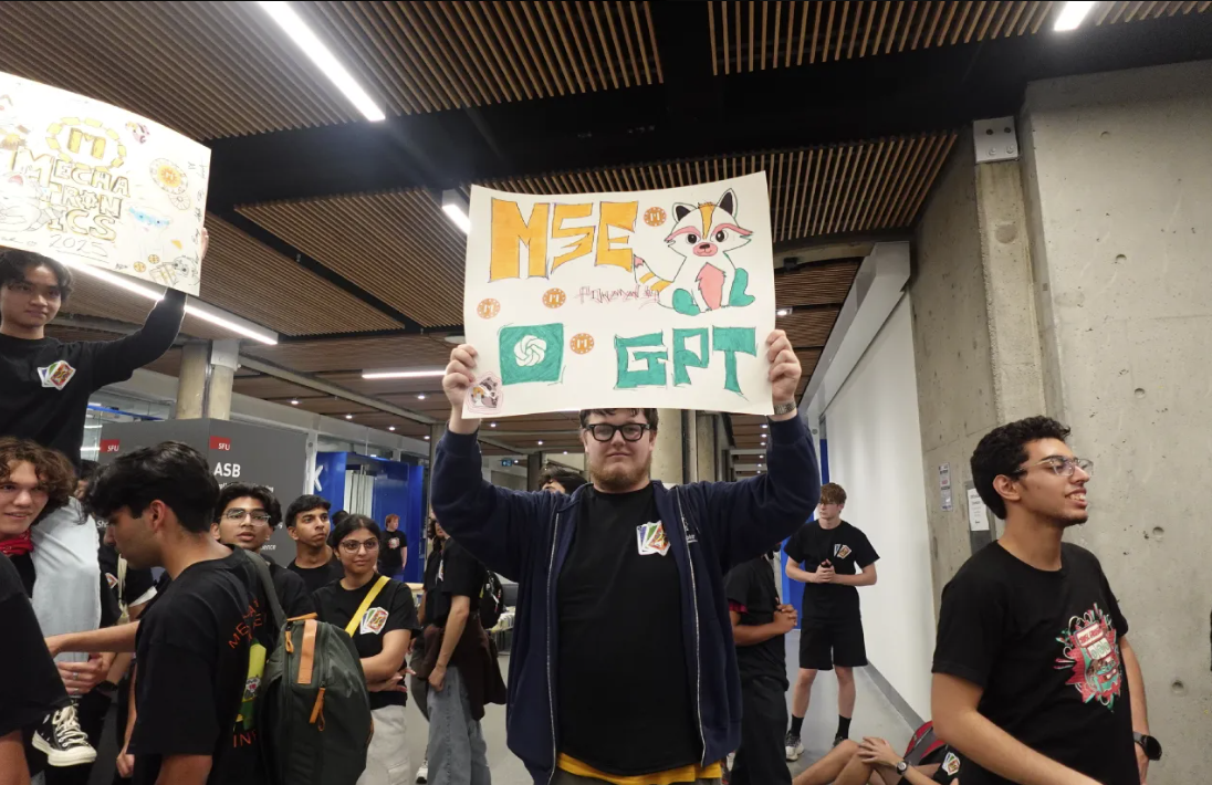 Student holding a colourful engineering sign