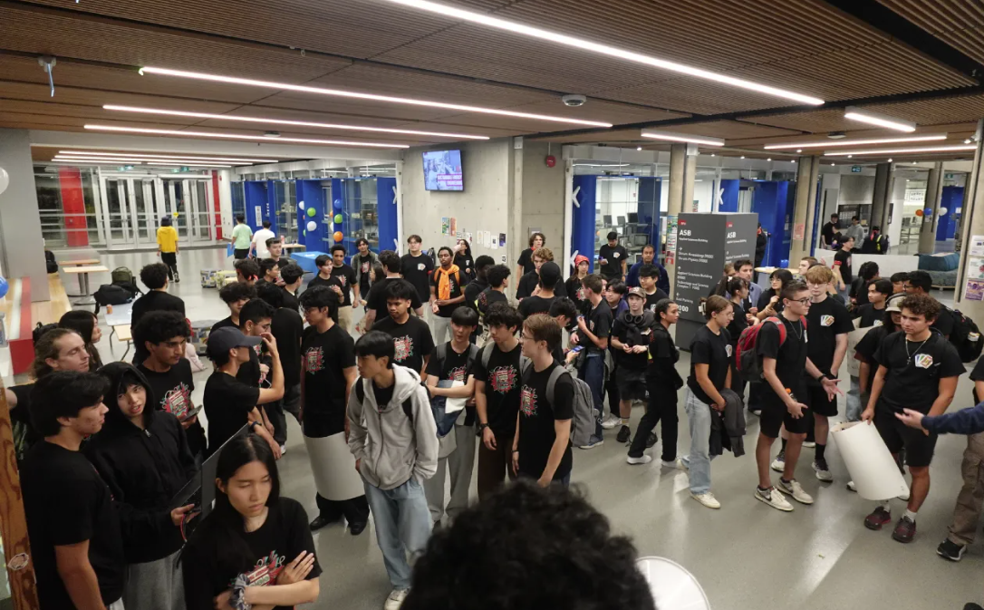 Large group of students gathered in a campus hallway